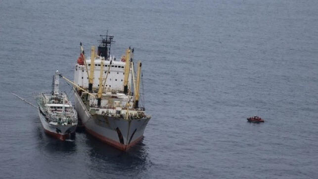 A fishing vessel transfers cargo to a reefer ship on the high seas (USCG file image)